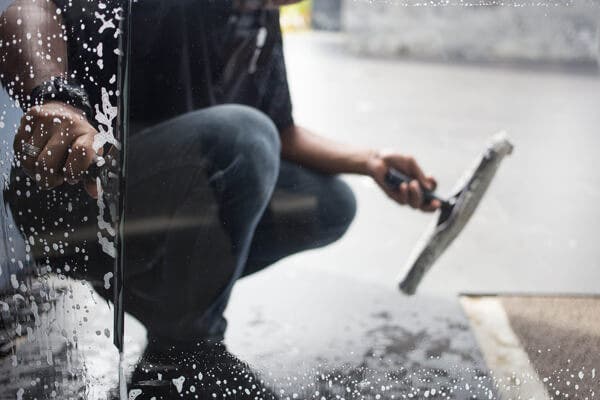wiping soapy water from glass